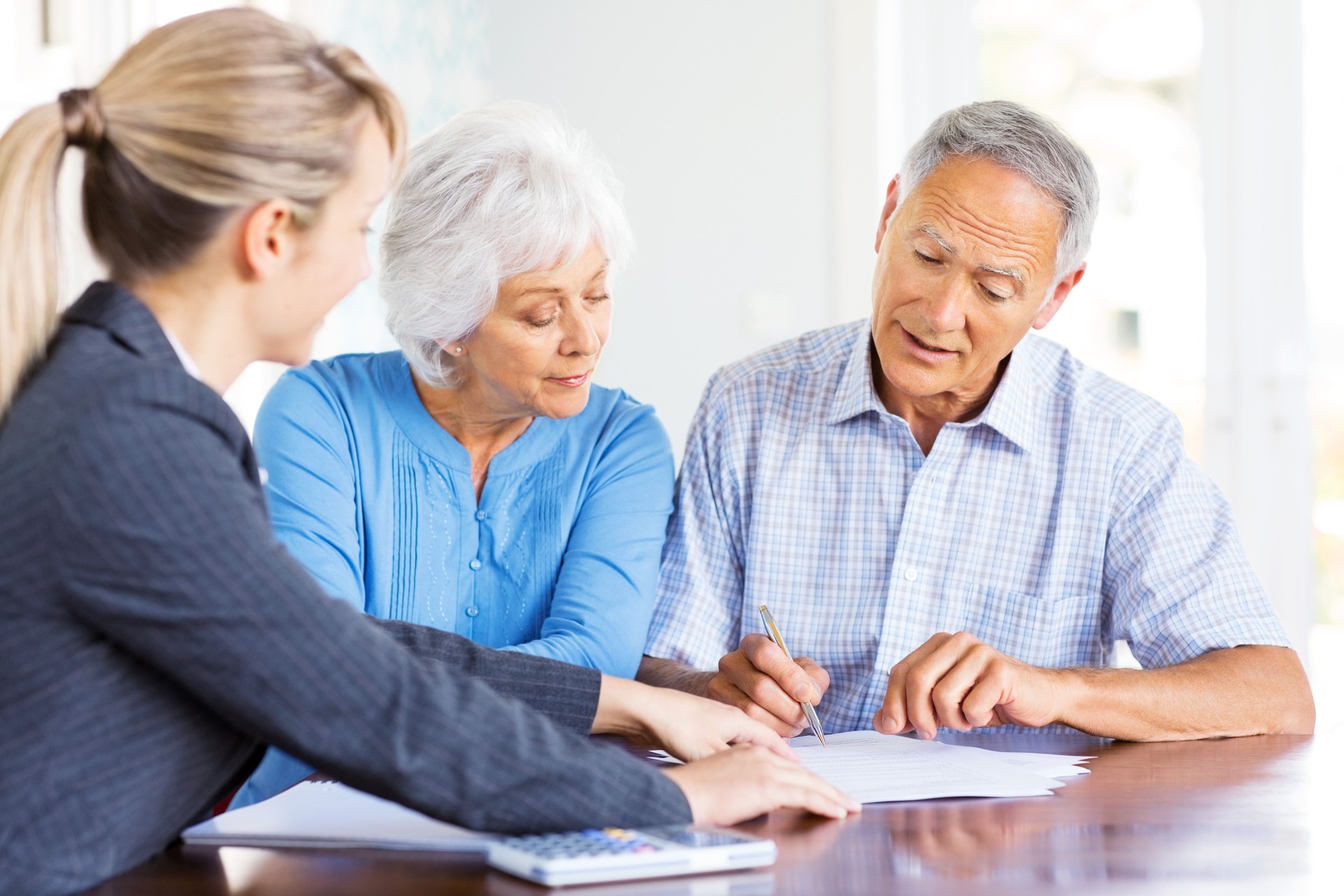 Financial Advisor Explaining Investment Plans To Senior Couple.